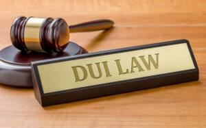 A wooden gavel rests on a DUI defense lawyer's desk near a plaque to symbolize the Georgia DUI laws and penalties of 2026.